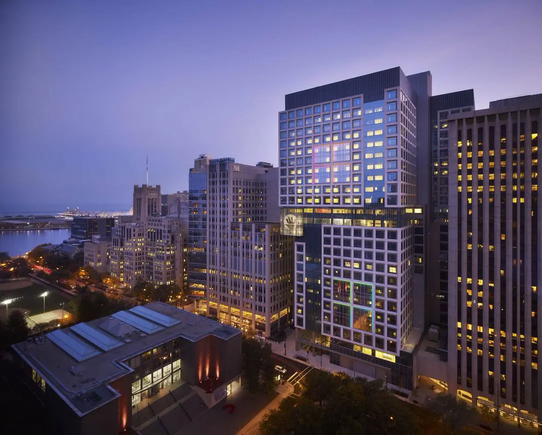 Illuminated city skyscrapers at dusk, overlooking urban landscape and buildings from elevated view