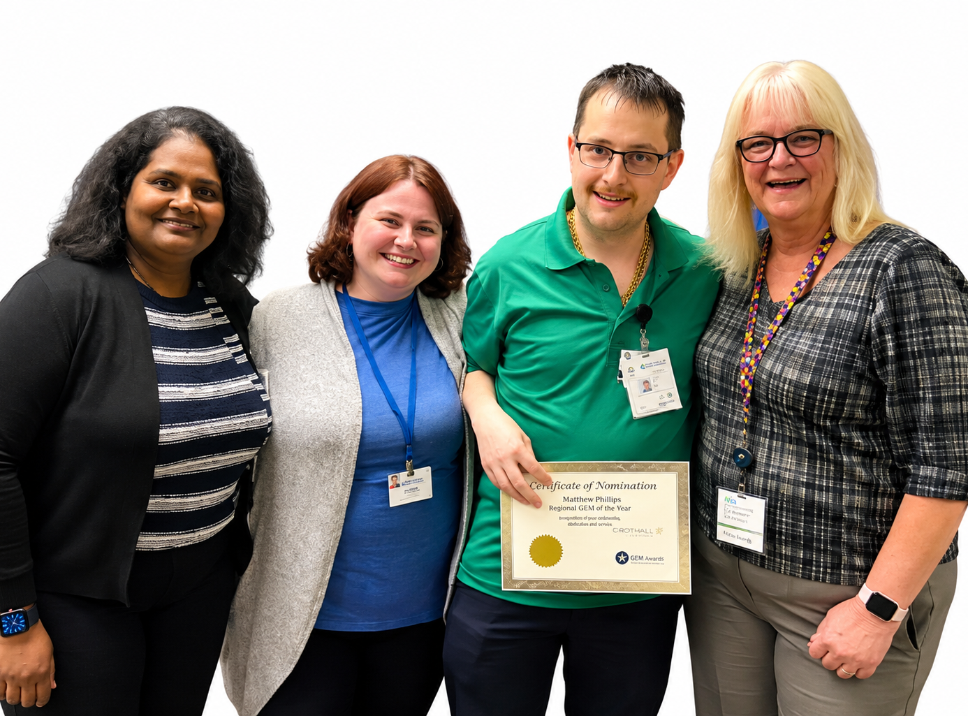 Matthew Phillips stands with colleagues while holding his Crothall Healthcare Regional GEM of the Year award certificate.